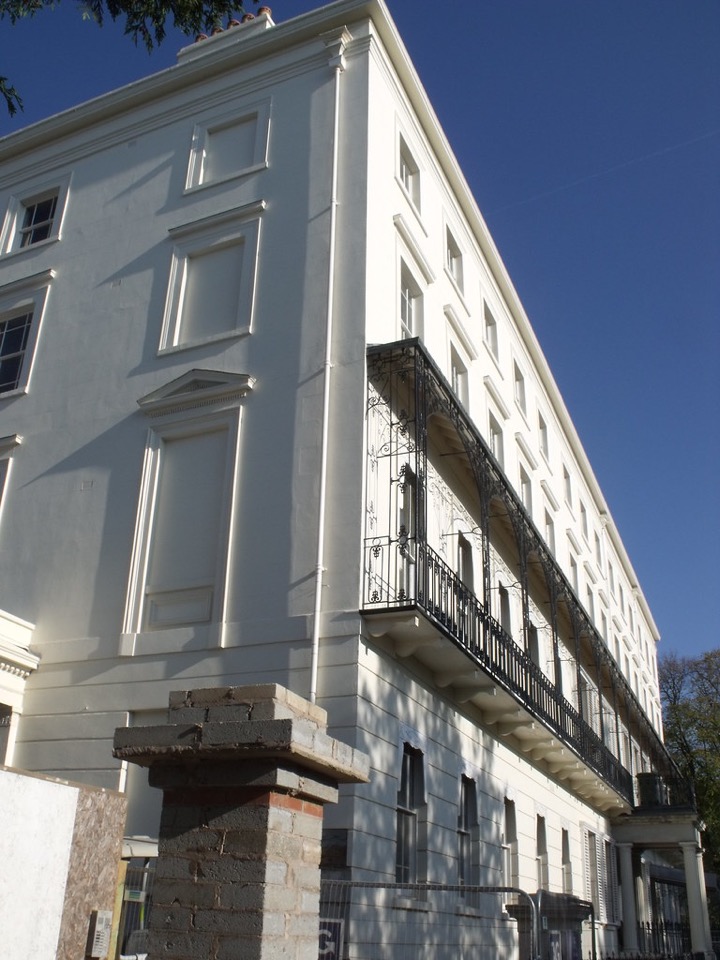 A cream Georgian terrace with black cast iron balconies